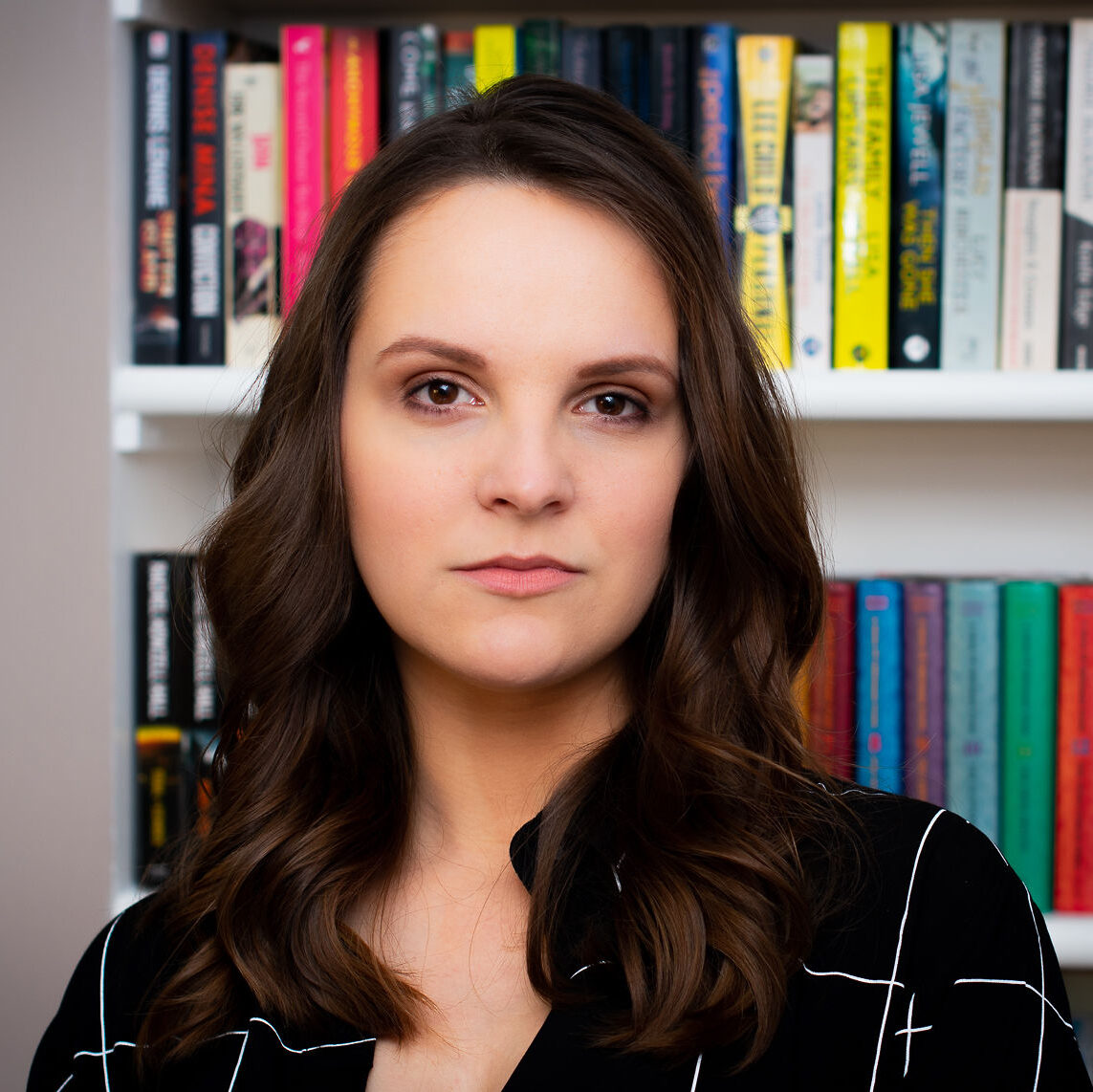 Author Becca Day standing in front of a bookcase